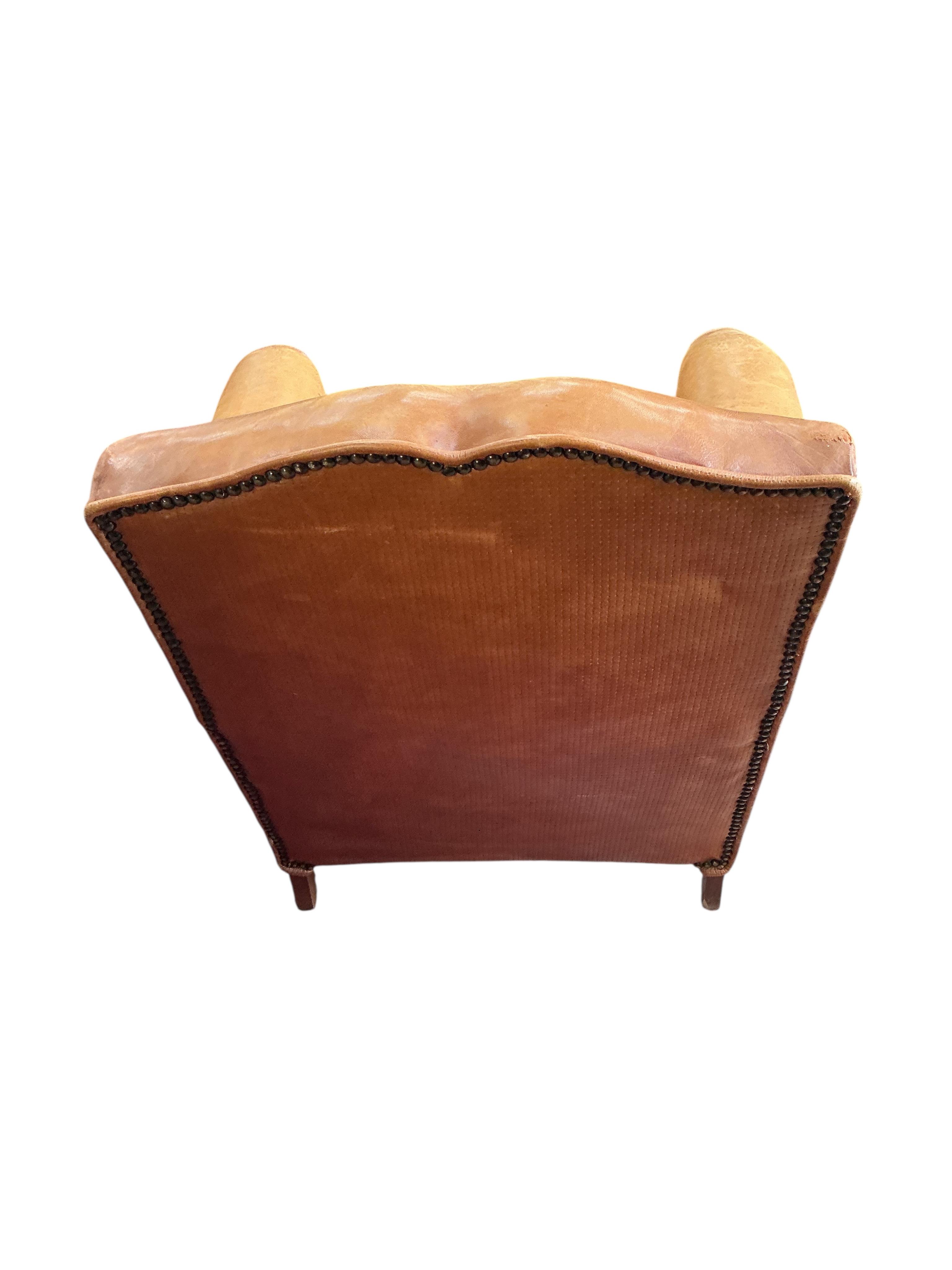 A French Art Deco tan leather club chair, width 73cm, depth 68cm, height 74cm